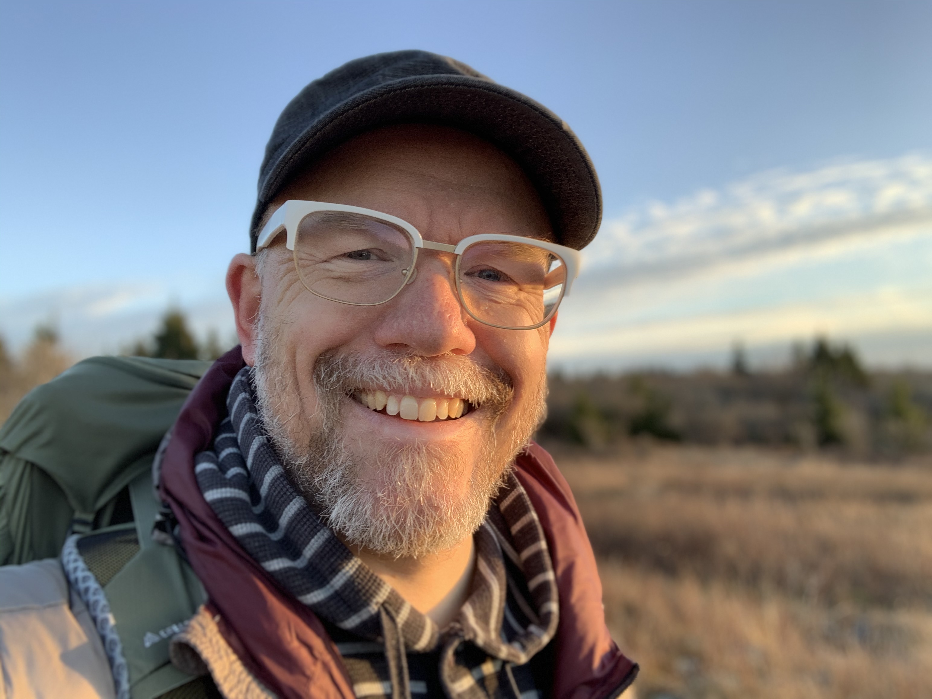 Headshot of a smiling Niklas Elmqvist wearing white glasses and a military cap.